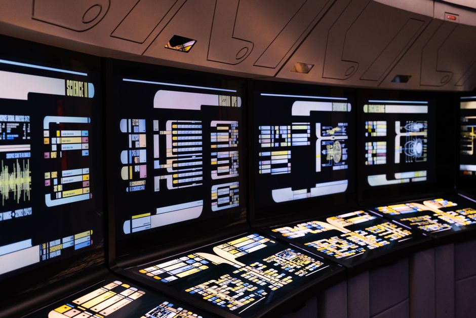 Automate solo business operations — A high-tech command center with illuminated digital screens in a futuristic setting.
